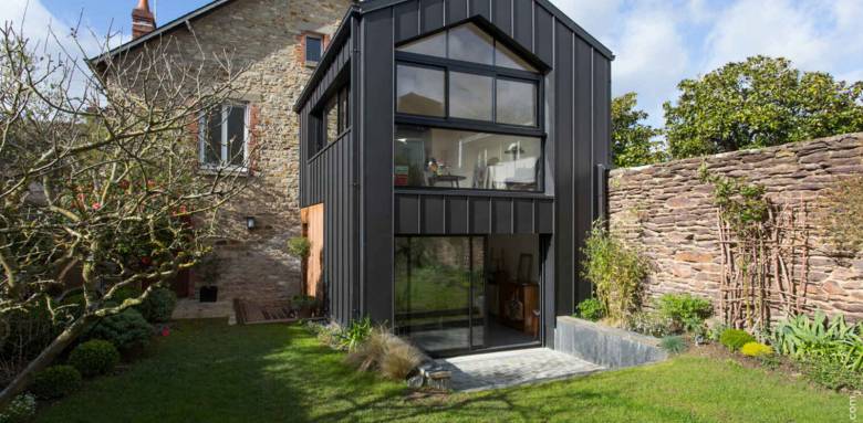 Extension en zinc vitrée sur maison en pierres
