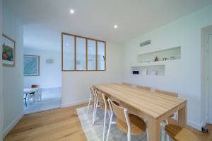 La chaleur du bois et la pureté du blanc dans cette salle à manger