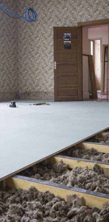 Laine isolante placée entre les solives du plancher
