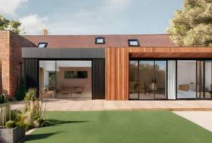 Une extension de maison moderne qui contraste avec le bâti classique