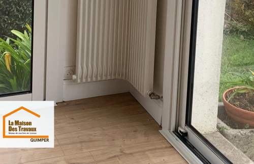 Finitions précises autour des murs et radiateurs après pose du nouveau sol, incluant une sous-couche pour améliorer confort et longévité du revêtement.