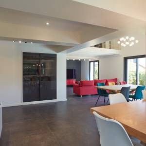 Salon lumineux ouvert sur la cuisine après extension – Maison T. à Saint Genis les Ollières