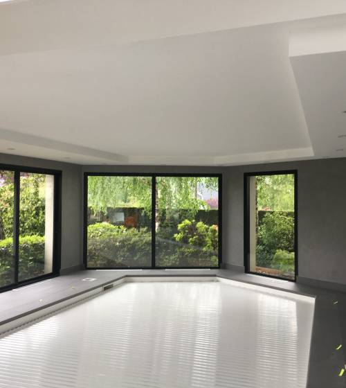 construction d'une piscine couverte dans une extension avec baie vitrée 