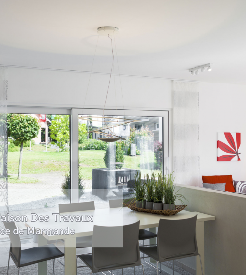 L'espace lumineux de la salle à manger avec de grandes baies vitrées, offrant une vue dégagée sur le jardin.