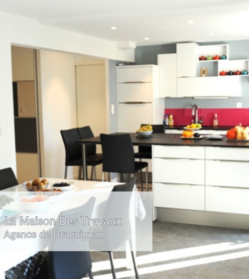 Vue d’ensemble de la cuisine rénovée avec un îlot central accueillant et une table à manger à proximité pour plus de convivialité.