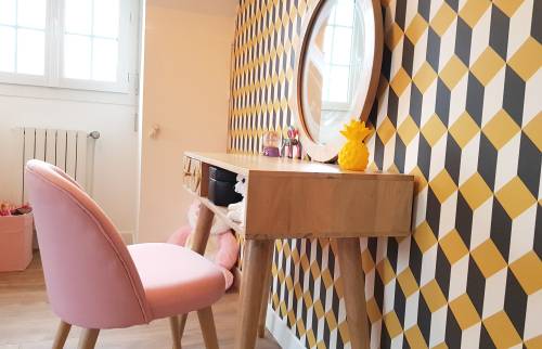 coiffeuse en bois clair avec fauteil rose poudre et papier peint 