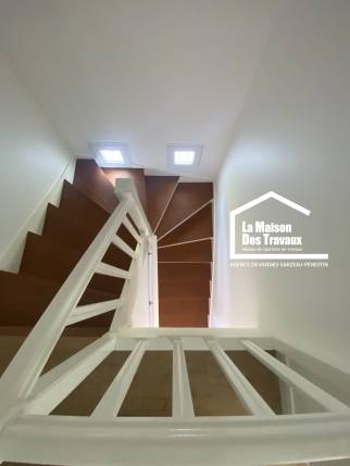 Escalier en bois rénové avec garde-corps blanc dans le cadre d’une rénovation globale à Damgan