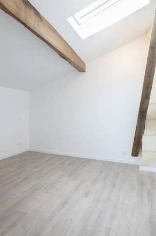 Chambre sous les combles avec poutres apparentes