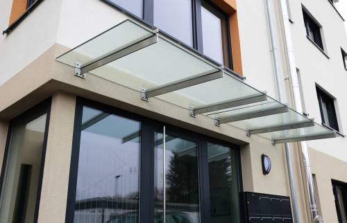 Ravalement de façade avec pose finale d'une auvent sur mesure devant hall immeuble à Douarnenez (29100)