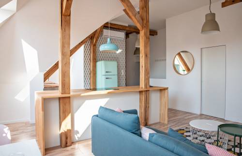 Aménagement de combles avec poutre en bois apparente 