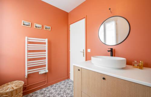 Murs de couleur rouge audacieuse dans une salle de bain moderne à Paris 8e