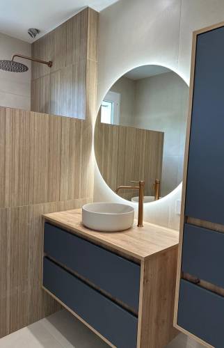 Meuble vasque suspendu sur mesure, miroir rétroéclairé et ambiance chaleureuse pour cette salle de bain rénovée à Voiron.