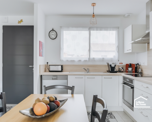 Rénovation d’une maison à Aix-en-Provence avec cuisine ouverte sur le séjour, espaces lumineux et aménagement intérieur modernisé.