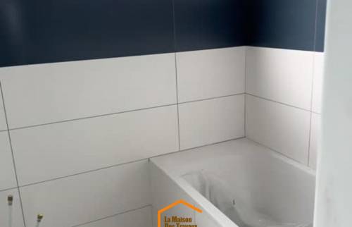 Habillage mural en faïence blanche  – rénovation salle de bain avec carreaux de ciment au sol à Saint-Brieuc