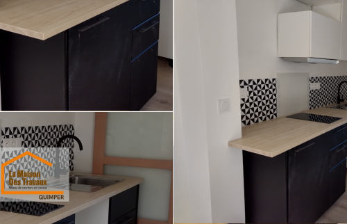 Cuisine moderne noir et bois rénovée à Quimper, alliant élégance, praticité et finitions soignées pour un intérieur contemporain et chaleureux.