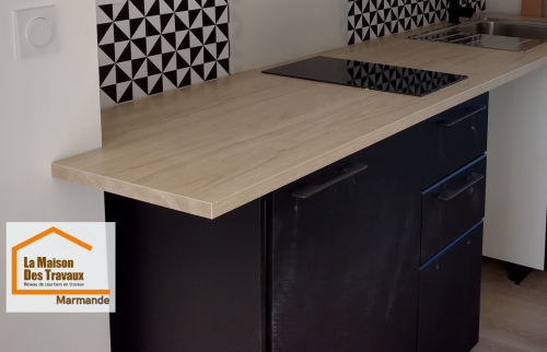 Cuisine fonctionnelle rénovée à Marmande avec plan de travail effet bois, rangements optimisés et électroménager intégré pour un logement locatif attractif.