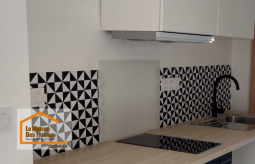 Pose d’une crédence graphique noir et blanc dans une cuisine rénovée à Quimper, créant une ambiance moderne et personnalisée.
