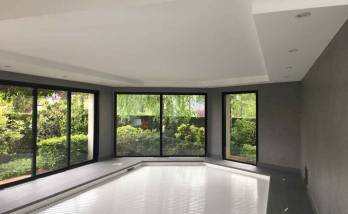 Piscine intérieure avec baies vitrées