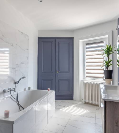 Rénovation complète d'une salle de bains, carrelage imitation marbre blanc et peintures bleu gris