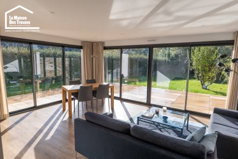 Aménagement d’une pièce de vie moderne avec baie vitrée d’angle