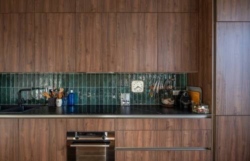 Crédence moderne et robinet noir dans une cuisine rénovée à Paris 8e.