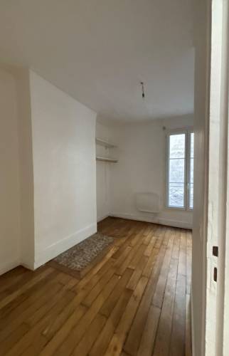 Pièce à vivre avant travaux, parquet ancien et fenêtre parisienne