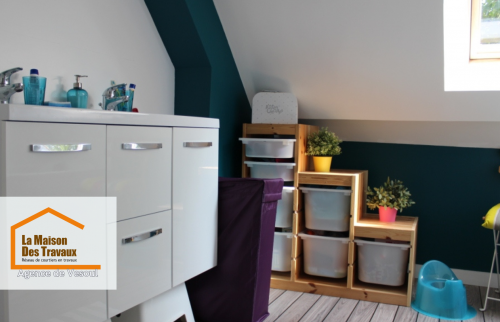 Salle de bain moderne sous combles à Saint-Loup-sur-Semouse - Rénovation lumineuse avec mobilier blanc laqué et touches de vert pour une ambiance fraîche et fonctionnelle.