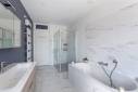 Rénovation complète d'une salle de bains, carrelage imitation marbre blanc et peintures bleu gris