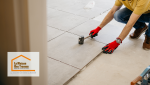 Sur cette image, on peut voir un artisan professionnel, équipé des outils appropriés, procéder à la pose des carreaux. 