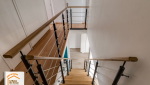 structure escalier métal noir, escalier bois massif sur-mesure, rénovation intérieure Sallanches, aménagement duplex design, menuisier Sallanches