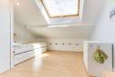 Chambre sous toiture lumineuse avec parquet