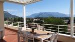 Pergola bioclimatique avec lames ouvertes sur une terrasse d’appartement à Voiron, offrant une vue dégagée sur les massifs du Pays Voironnais.