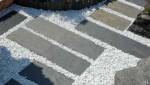 dalles en ardoise sur gravier blanc pour permettre un passage facilité aux poussettes