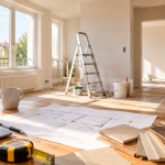 Préparation d'un projet de rénovation d'appartement avec plans, échantillons de matériaux, outils et pièce en cours de travaux.