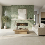 Salon moderne avec mur en carrelage vert type zellige autour d’une cheminée, grande baie vitrée et carrelage grand format au sol.